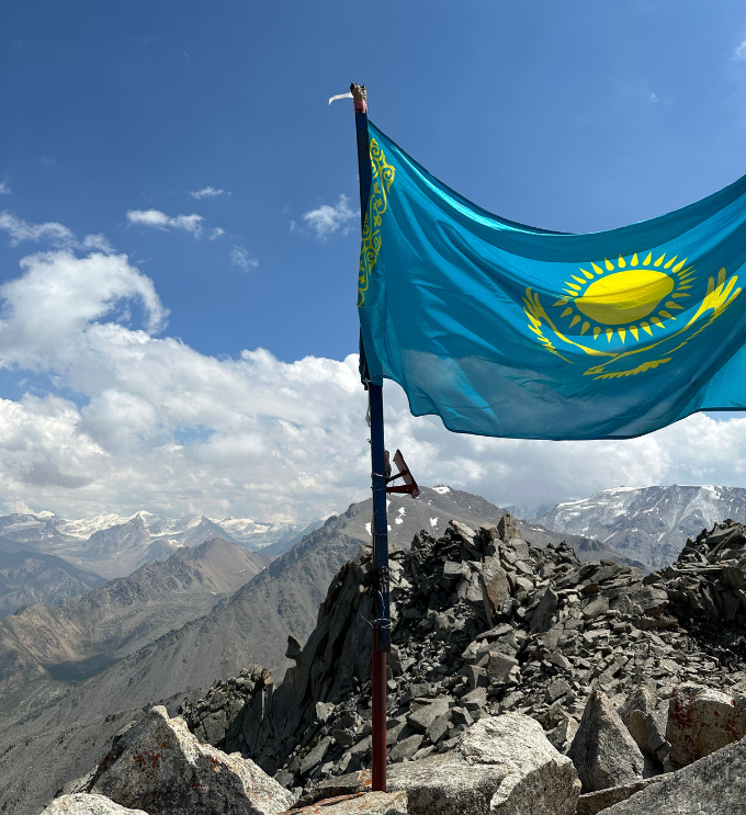 Kazakh flag on mountain summit